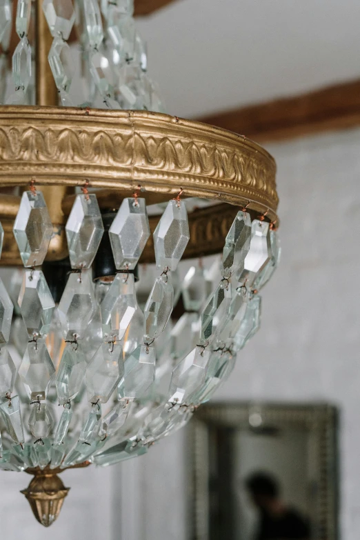 a chandelier hanging from a ceiling in a room, award - winning details, stone and glass and gold, medium close shot, julia sarda