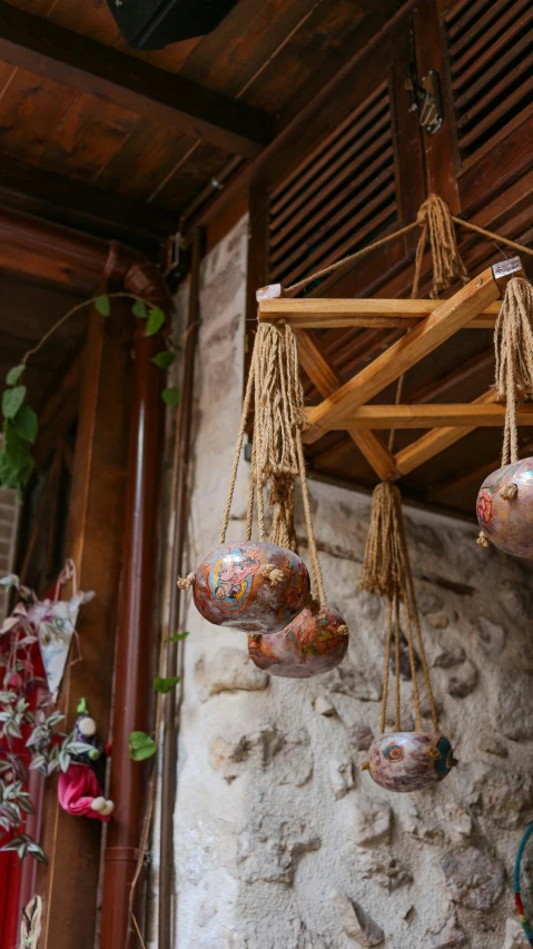 a bunch of food hanging from the ceiling, inspired by Riad Beyrouti, wooden decoration, medium close shot, raku, shop front