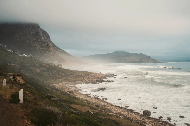 a view of the ocean from the top of a hill, by Daniel Seghers, unsplash contest winner, light grey mist, south african coast, ocean storm, three - quarter view