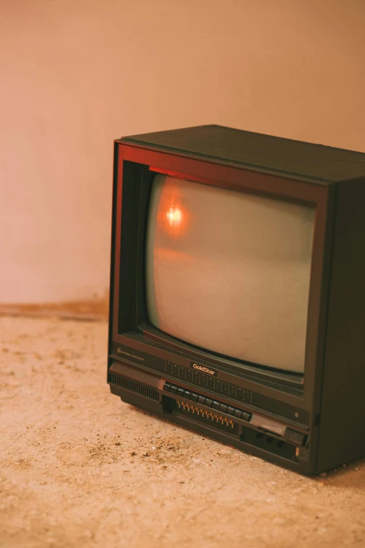 a small television sitting on top of a floor, by Elsa Bleda, trending on pexels, video art, vhs cover, screen light, 1 9 8 0 s photo, instagram post