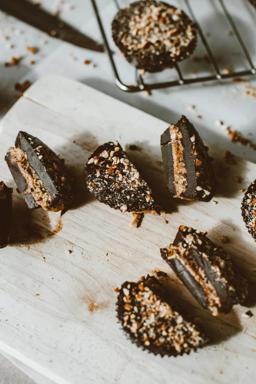 a wooden cutting board topped with pieces of chocolate, by Jessie Algie, unsplash, cannonballs, very crispy, thumbnail, indoor shot