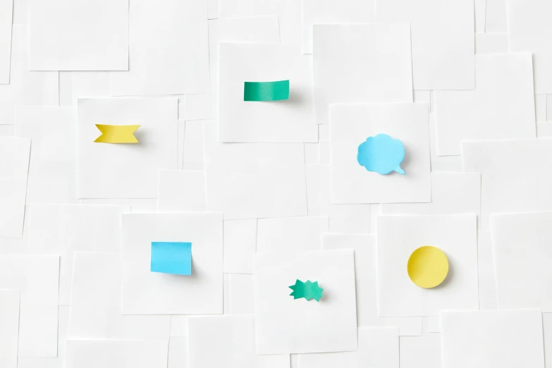 a number of pieces of paper on a white surface, trending on pexels, speech bubbles, yellow and blue and cyan, square sticker, hd artwork