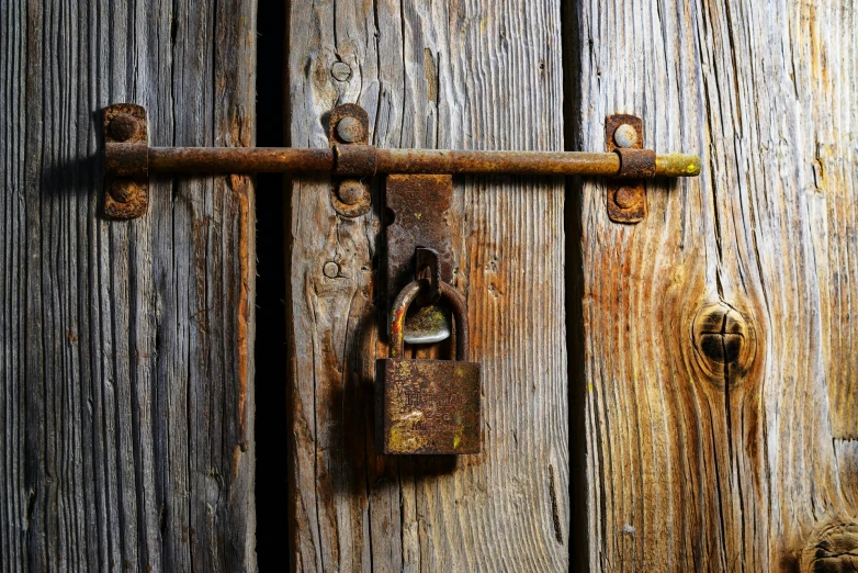 a close up of a lock on a wooden door, an album cover, medieval photograph, ((rust)), mobile wallpaper, ready to eat