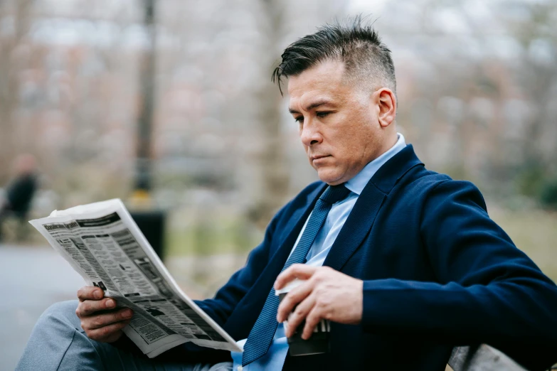 a man sitting on a bench reading a newspaper, pexels contest winner, private press, wearing dark blue suit, christopher cao, profile image, thumbnail