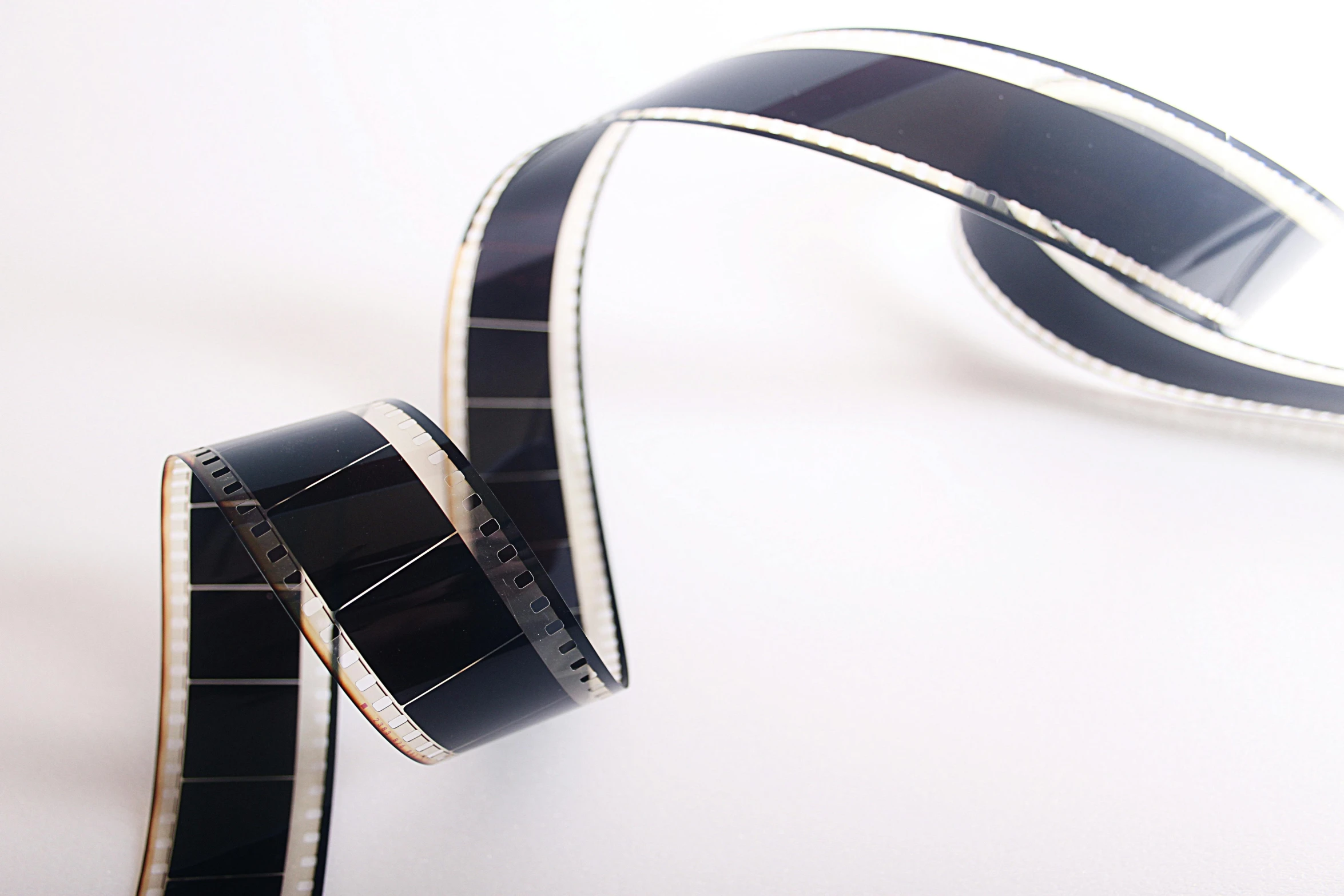 a roll of film sitting on top of a table, film key art, archive photograph, ribbon, movies