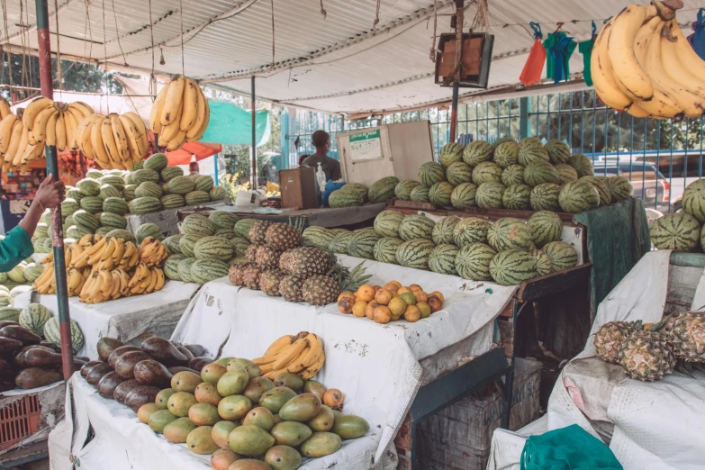 a market filled with lots of different types of fruit, unsplash, unmistakably kenyan, square, on a bright day, conor walton