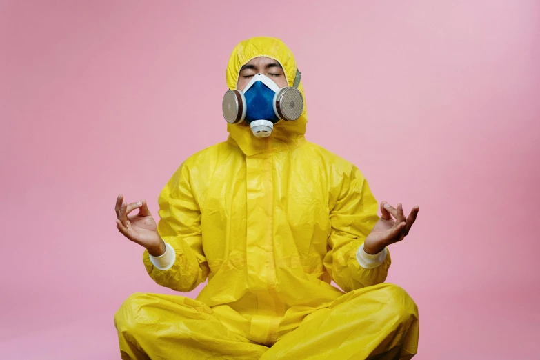 a man in a yellow hazmat suit meditating, an album cover, by Julia Pishtar, pexels, pink, dangerous chemical hazards, cleaning future, local conspirologist