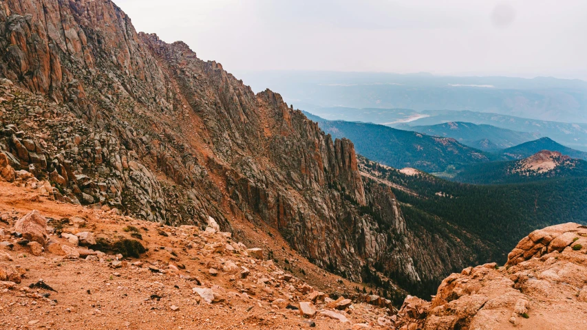 a view of the mountains from the top of a mountain, by Morgan Russell, unsplash contest winner, geological strata, 2000s photo, rocky cliffs, high quality product image”