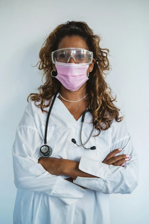 a woman in a lab coat wearing a mask and a stethoscope, inspired by Dr. Atl, pexels, wearing robes and neckties, diverse, photo for magazine, white and pink cloth