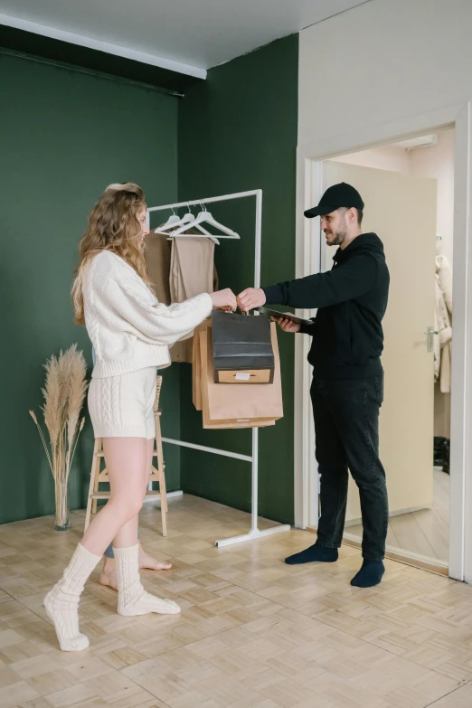 a man standing next to a woman in a room, ecommerce photograph, opening, clothing drop, thumbnail