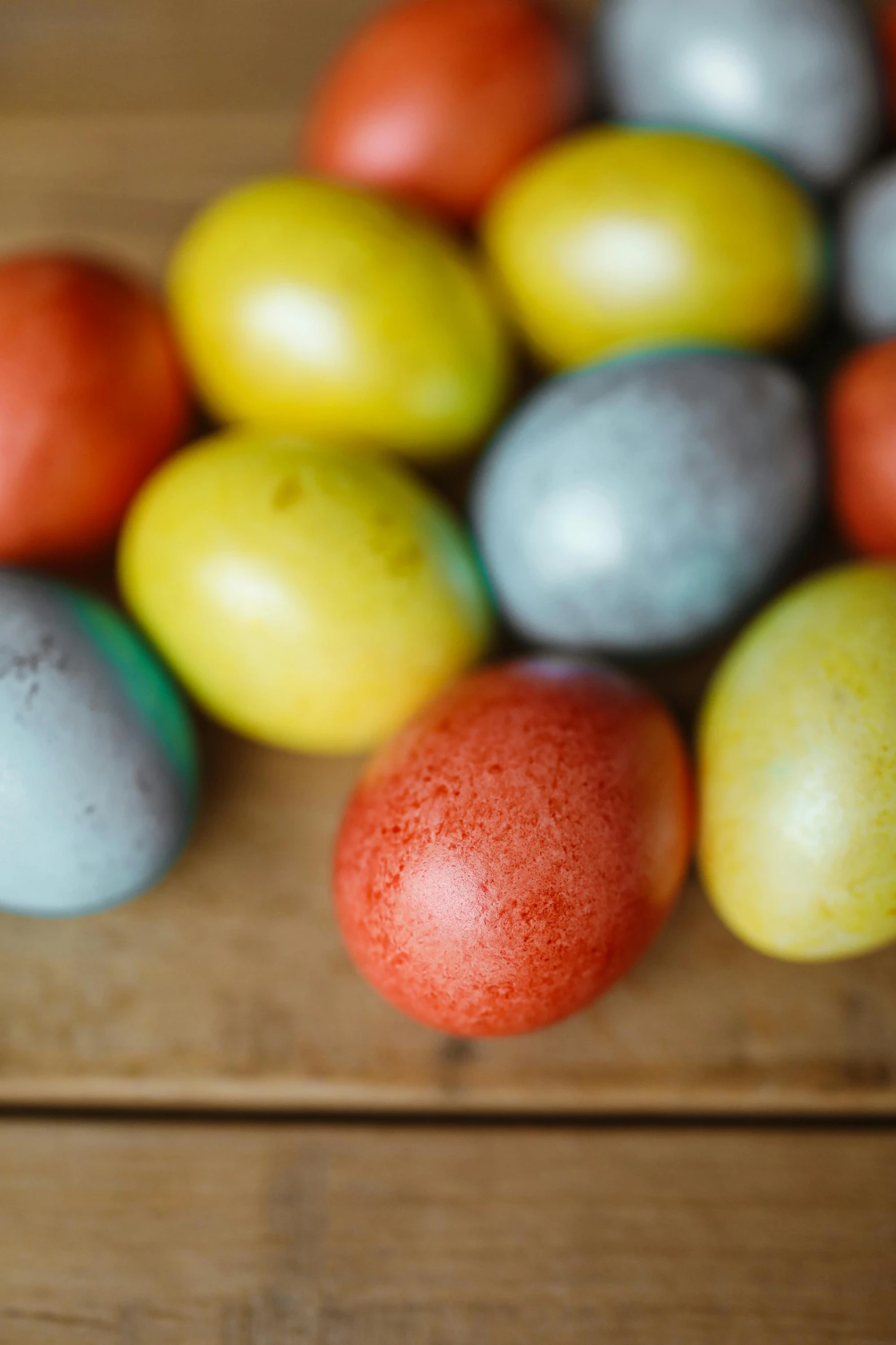 a pile of colored eggs sitting on top of a wooden table, on a wooden tray, thumbnail, subtle detailing, polish