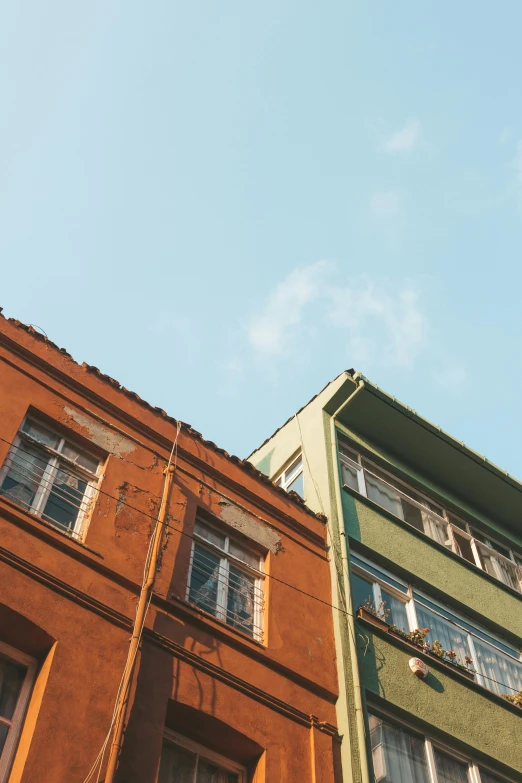 a couple of buildings that are next to each other, inspired by Elsa Bleda, trending on unsplash, modernism, nepali architecture buildings, low angle shot, color image