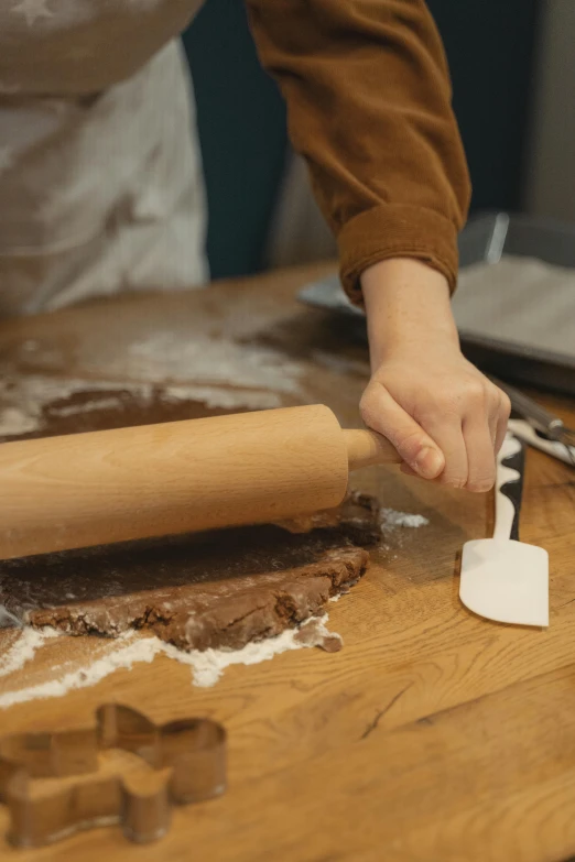 a person rolling out dough on a wooden table, inspired by Jan Kupecký, trending on pexels, square, brown, animation, piping