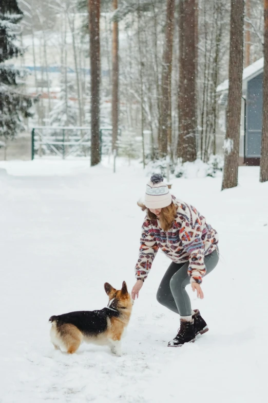 a woman playing with a dog in the snow, by Julia Pishtar, backyard, skiing, profile image, multiple stories