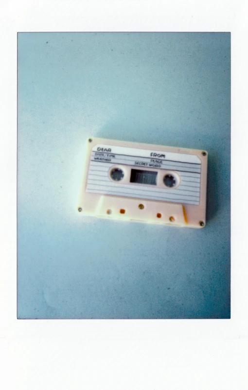 a white cassette sitting on top of a blue surface, by Awataguchi Takamitsu, instagram, digital photo, 1 9 8 0 s photo, impasto, musical