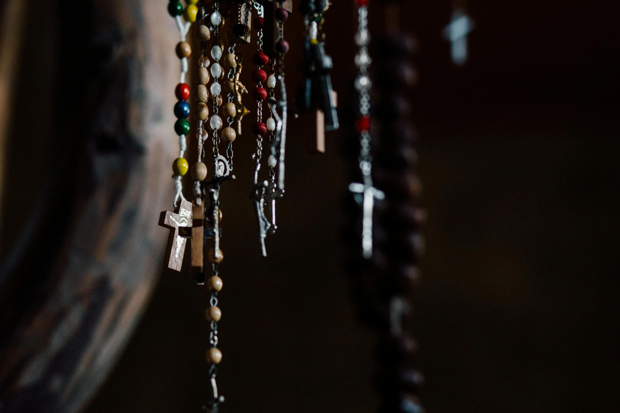 a close up of a bunch of rosary beads, a portrait, unsplash, wind chimes, instagram photo, crucifix, decoration around the room