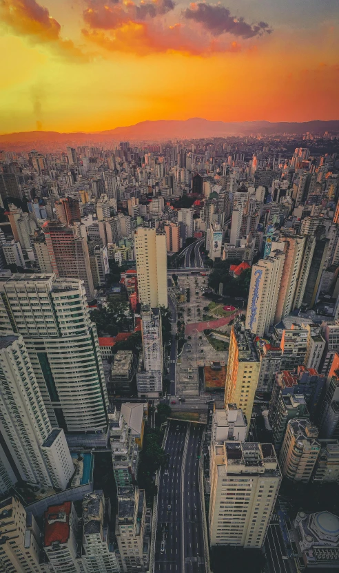 an aerial view of a city at sunset, an album cover, by Felipe Seade, pexels contest winner, brazilian, 8 k hi - res, multiple stories, skyline