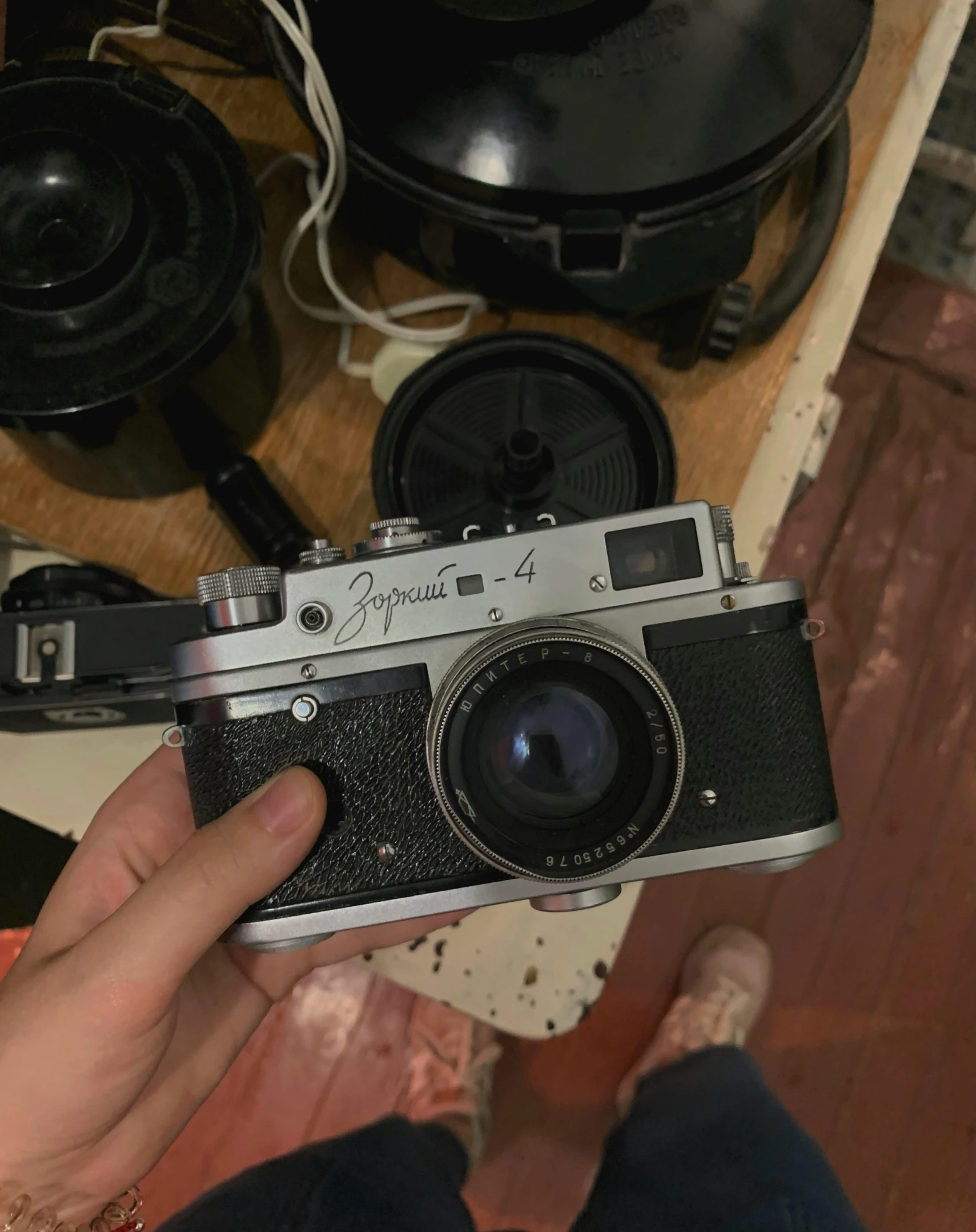 a close up of a person holding a camera, craigslist photo, film artifacts, f/1.4, mid shot photo