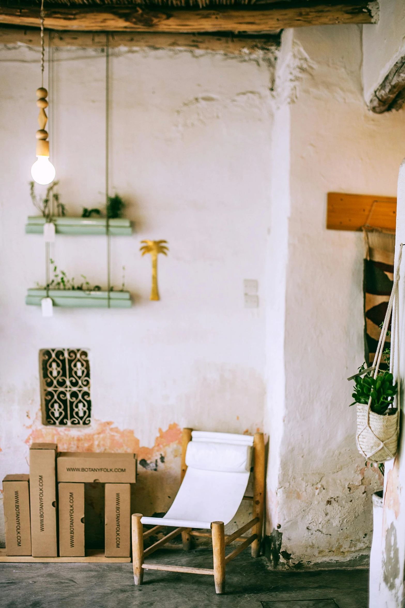 a room that has a chair and a table in it, trending on unsplash, lots of jars and boxes of herbs, whitewashed buildings, things hanging from ceiling, promo image