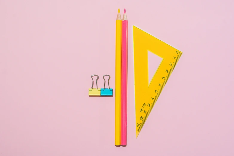 two pencils and a ruler on a pink surface, by Adam Marczyński, trending on pexels, postminimalism, triangles, colors: yellow, colorful medical equipment, triangular elements