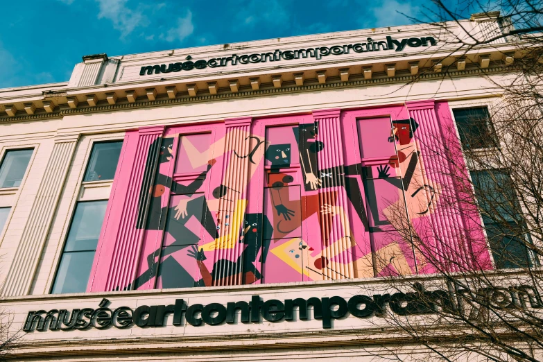 a building with a mural on the side of it, a cartoon, by Ben Thompson, temporary art, neon pink and black color scheme, music, carrington, featured in artscape