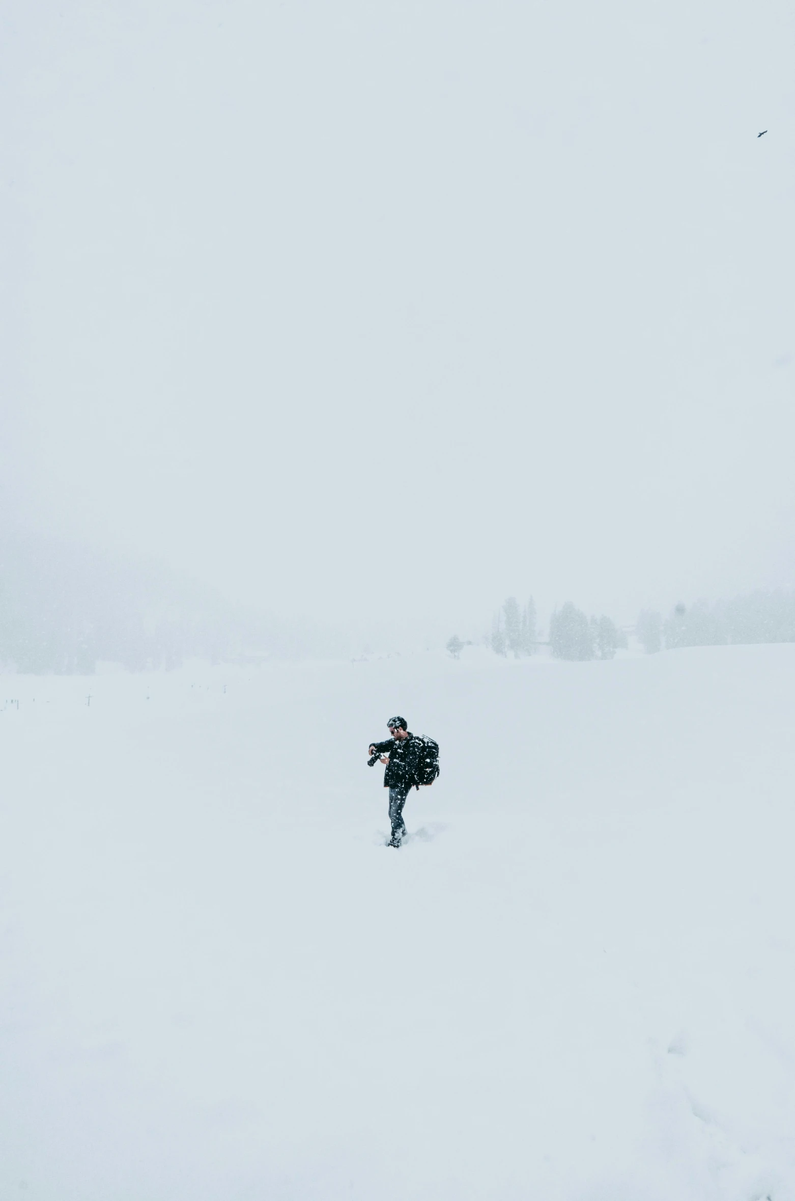 a man walking across a snow covered field, unsplash contest winner, ffffound, carrying survival gear, white space, sport