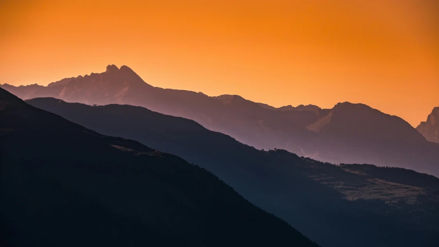 a plane flying over a mountain range at sunset, by Cedric Peyravernay, pexels contest winner, romanticism, orange gradient, whistler, silhouetted, multiple layers