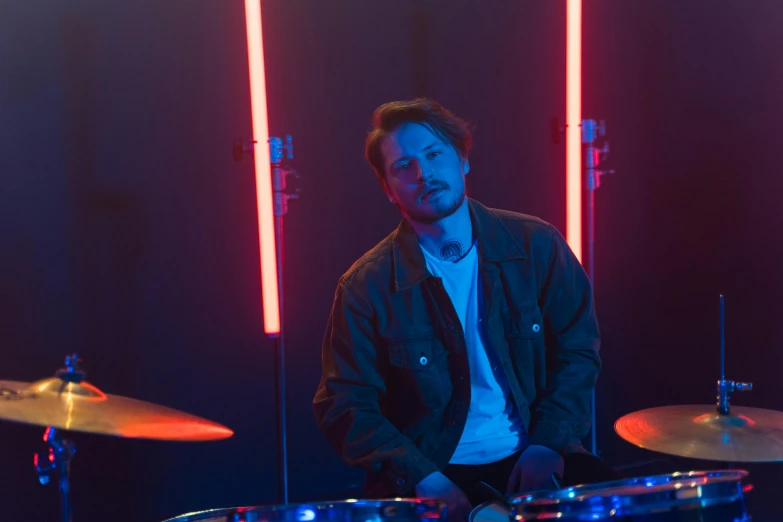 a man sitting in front of a drum set, cinematic neon uplighting, avatar image, caspar david, high res