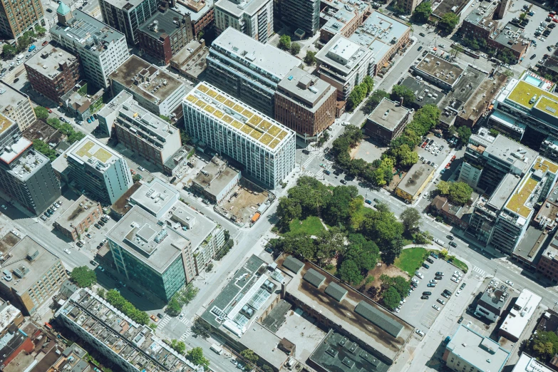 an aerial view of a city with lots of tall buildings, a photo, unsplash, vancouver school, green square, mcgill, grain”, photorealistic”