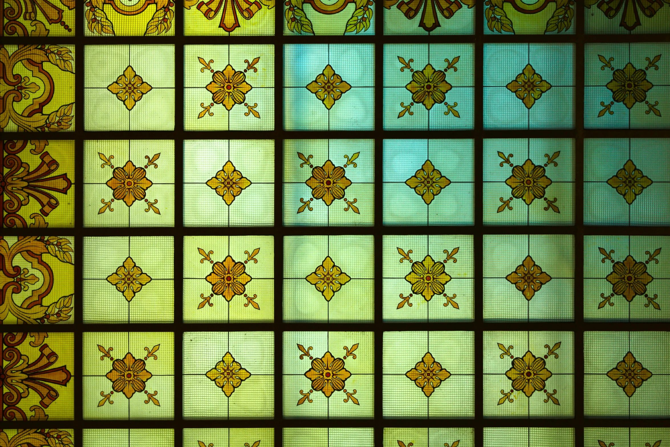 a close up of a stained glass window, simple ceiling, repeating patterns, green and yellow tones, 1759