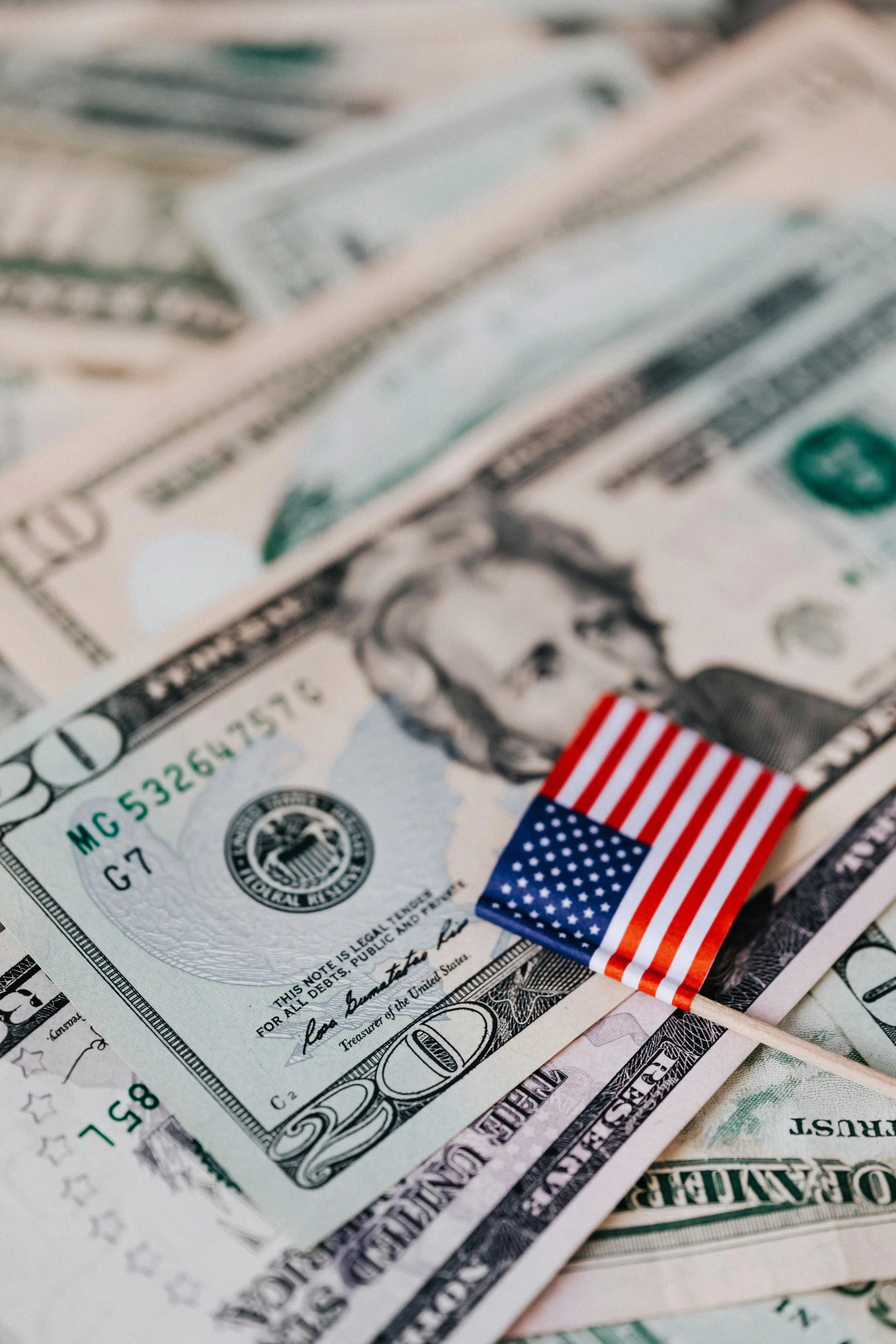 a flag sitting on top of a pile of money, thumbnail, us, highlight, upclose