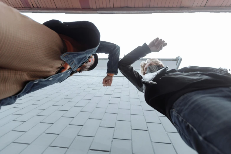 a couple of people standing next to each other, inspired by Leandro Erlich, pexels contest winner, happening, upside down stranger things, sharp roofs, cinematic mid shot fight, paw pov