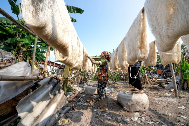 a man that is standing in the dirt, plasticien, fabrics and textiles, thumbnail, dried palmtrees, lined in cotton