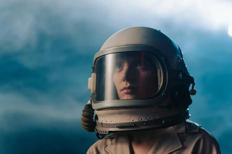 a close up of a person wearing a helmet, pexels contest winner, surrealism, beautiful woman in spacesuit, eleven from stranger things, girl wearing uniform, an astronaut lost in the ocean