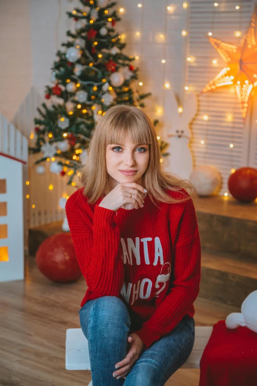 a woman sitting in front of a christmas tree, a portrait, by Julia Pishtar, pexels contest winner, russian girlfriend, with bangs, blonde hair and large eyes, 15081959 21121991 01012000 4k