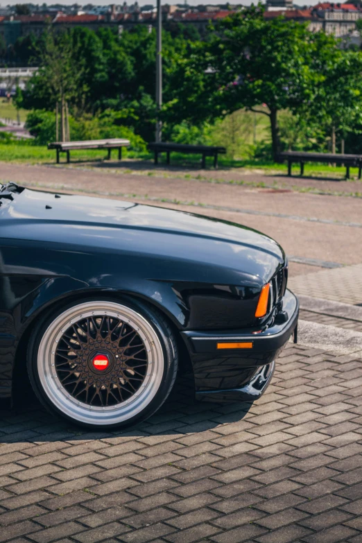 a black car parked on the side of the road, by Jan Tengnagel, pexels contest winner, renaissance, bmw e 3 0, restomod, made of swiss cheese wheels, soft top