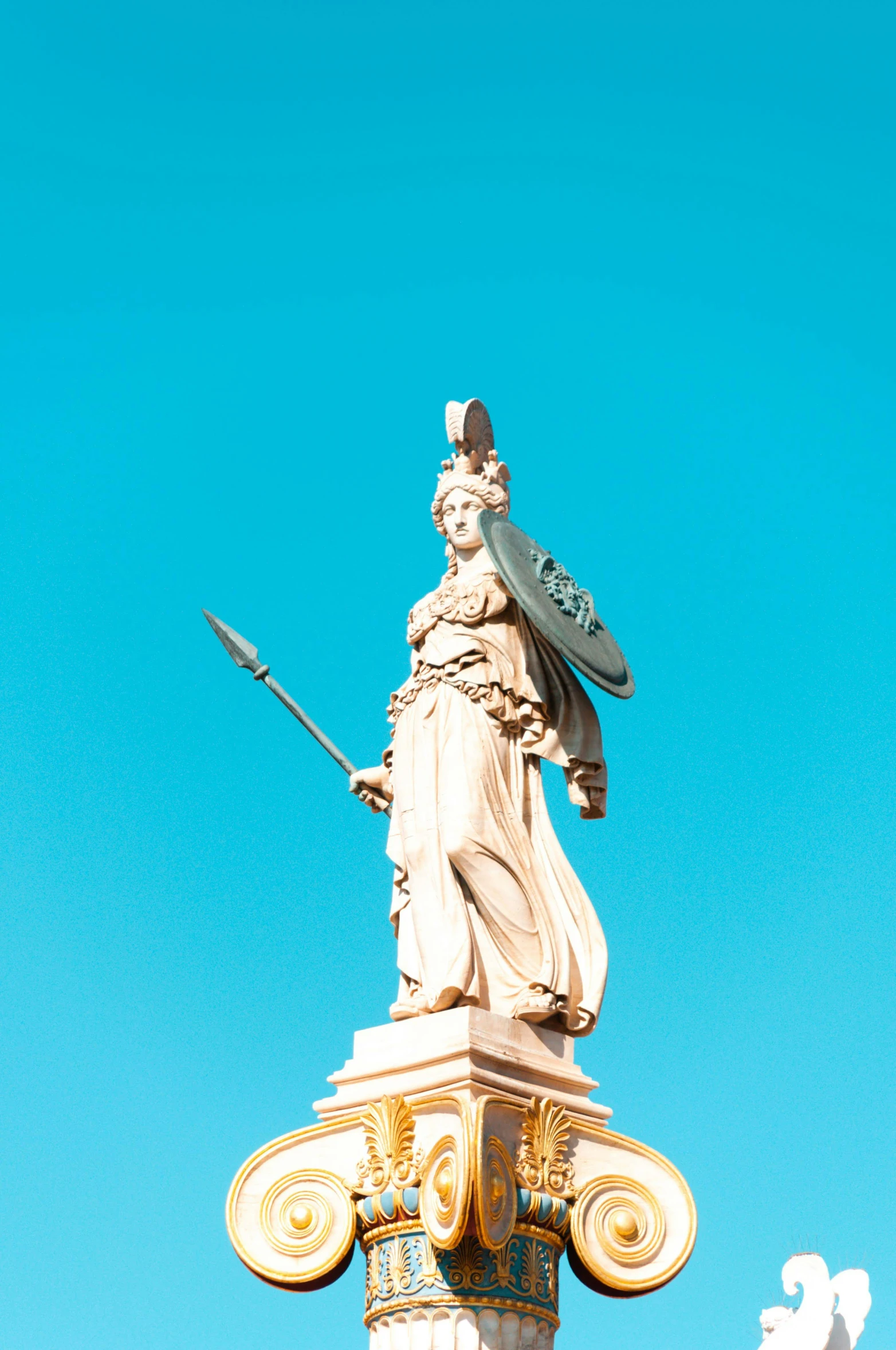 a statue of a woman holding a sword on top of a pillar, sky blue and white color scheme, athena, square, 1128x191 resolution