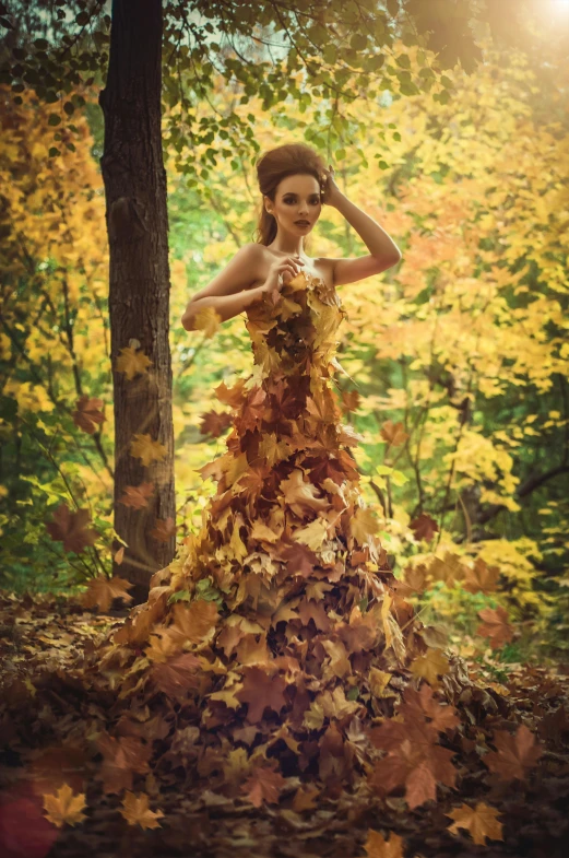 a woman in a dress made out of leaves, pexels contest winner, hyperrealistic fall, beautiful trees, style of julia razumova, stunningly realistic