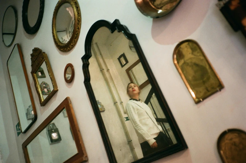 a man that is standing in front of a mirror, an album cover, unsplash, qajar art, quirky shops, gongbi, mirror hallways, aged 13