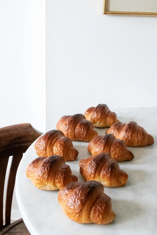 a table with a bunch of croissants on it, by Arthur Pan, 6 pack, lined up horizontally, petite, chocolate