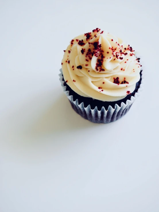 a cupcake with white frosting and red sprinkles, unsplash, black on white background, brown, thumbnail, unedited