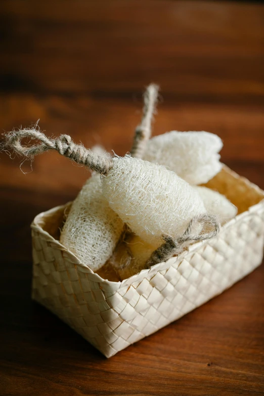 a basket of soap sitting on top of a wooden table, sea sponges, made of silk paper, bay area, petite