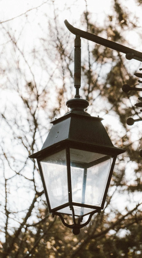 a street light hanging off the side of a building, unsplash, arts and crafts movement, low quality photo, close - up photo