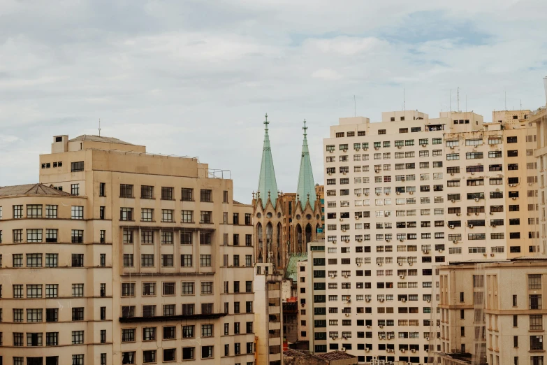 a group of tall buildings sitting next to each other, by Carey Morris, pexels contest winner, modernism, church cathedral, são paulo, zoomed out view, ravnica