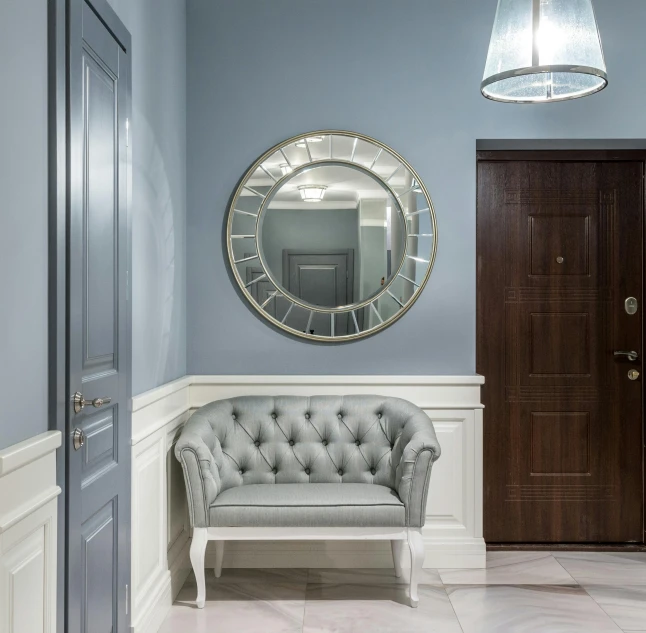 a living room filled with furniture and a mirror, inspired by Constantin Hansen, neoclassicism, apartment hallway, blue gray, round doors, grey and silver