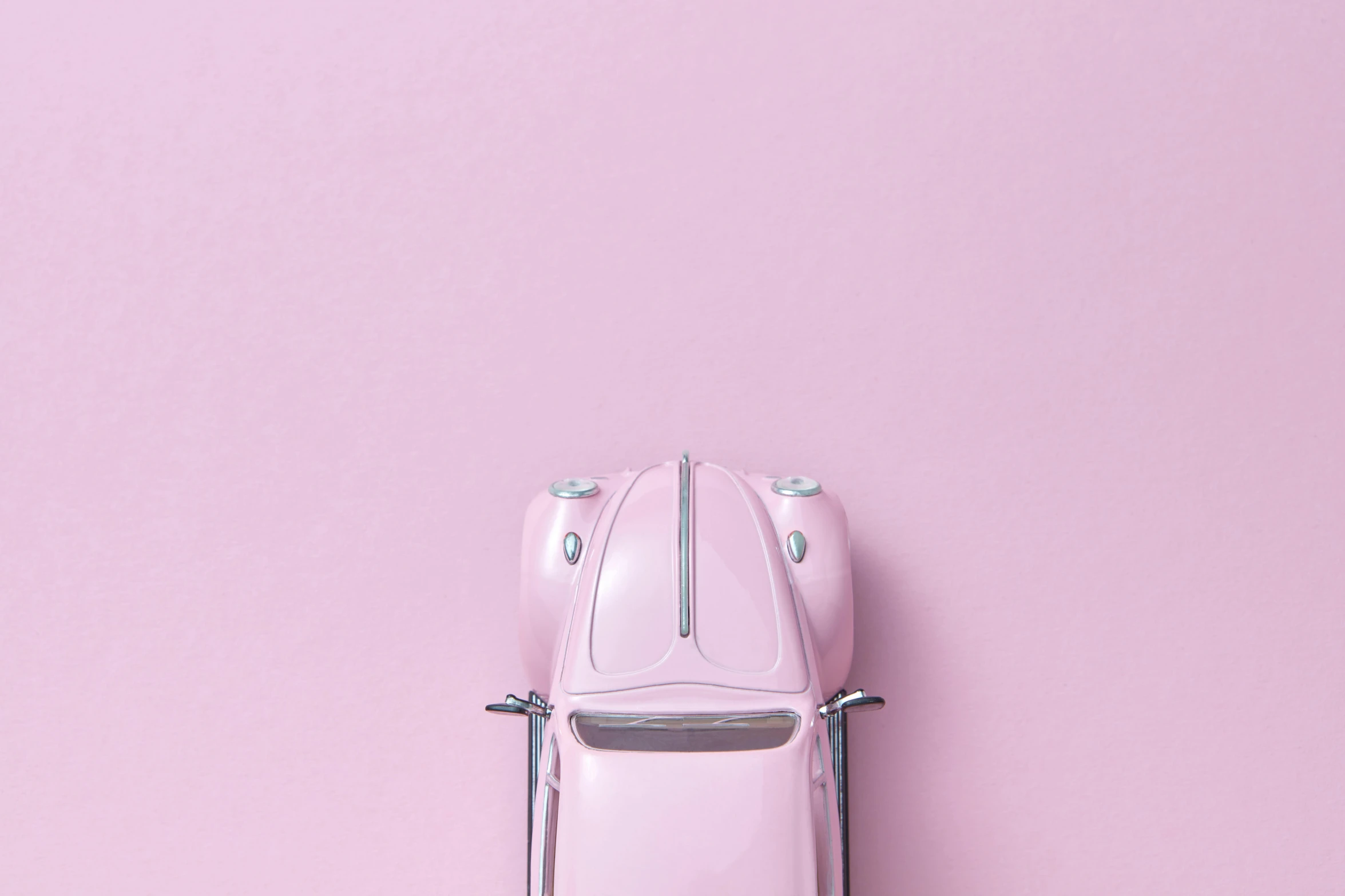 a pink toy car sitting on top of a pink wall, by Carey Morris, trending on unsplash, beetle, demur, light blush, mobile wallpaper