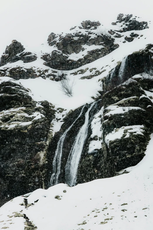 a man standing on top of a snow covered mountain, an album cover, pexels contest winner, hurufiyya, small waterfall, full frame image, winter photograph, stacked image