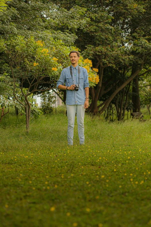 a man standing in a field with a frisbee, with nikon cameras, on a planet of lush foliage, raden saleh, full protrait