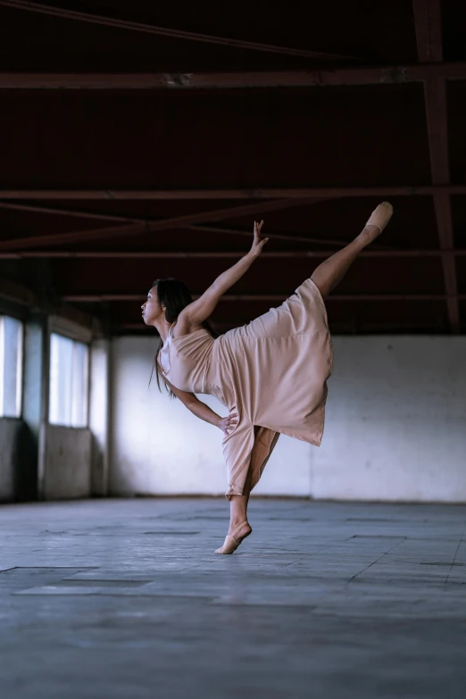 a woman standing on one leg in a dance pose, by Elizabeth Polunin, pexels contest winner, square, takato yomamoto. 4 k, vivid)