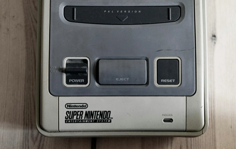 a video game console sitting on top of a wooden table, superflat, faded worn, nintendo official media, up close, instagram photo
